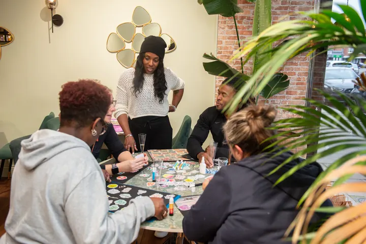 Faye coaching a small group of instructors around a table