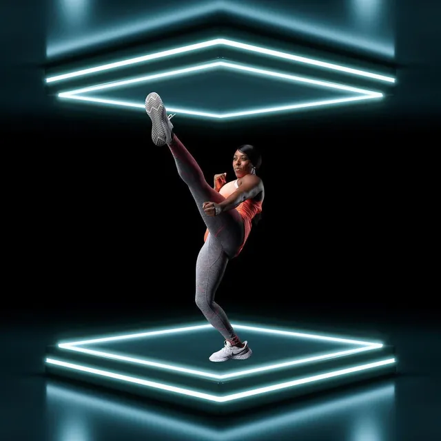 Faye mid high-kick between neon light frames